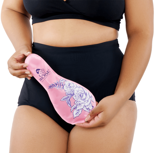 Lifestyle image of a postpartum woman wearing RoseRelief™ Postpartum Recovery Undergarment and holding the SoothingPetals™ Ice and Heat Pack by Rose Maternity Co.