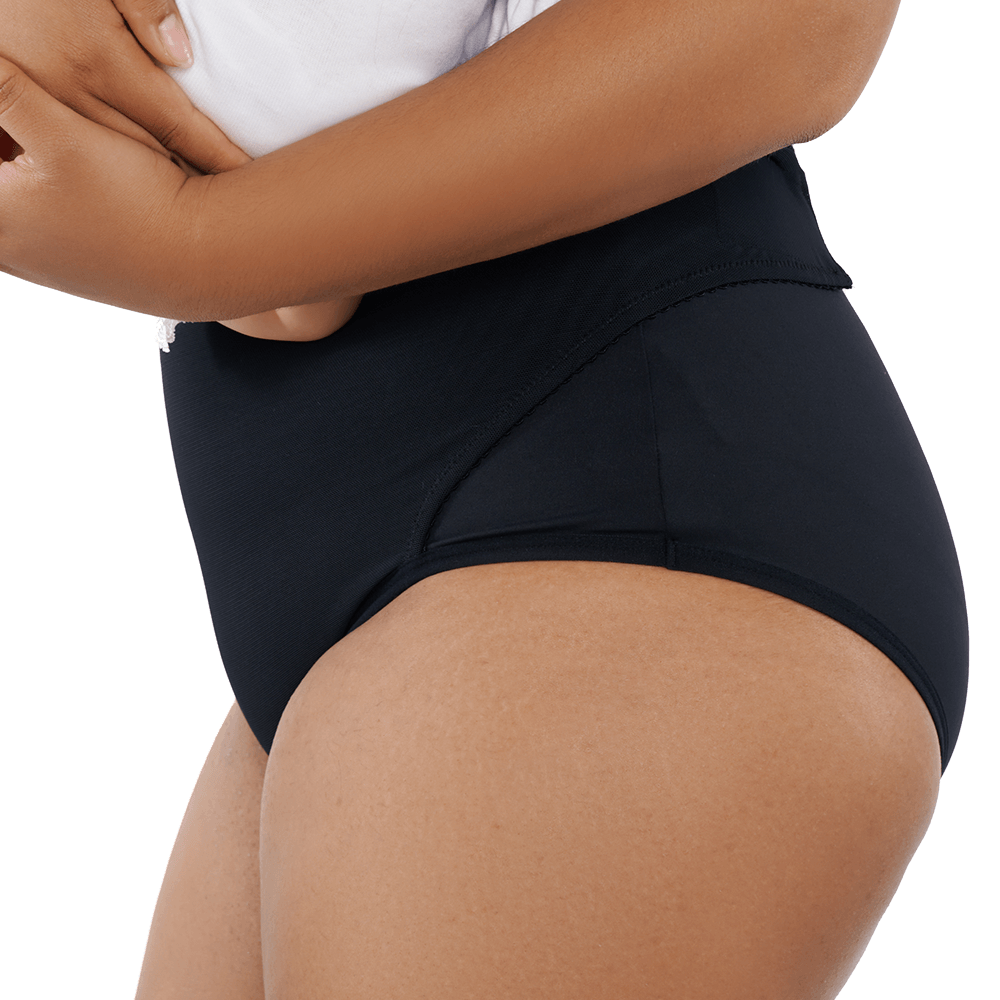 Lifestyle image of a postpartum woman wearing RoseRelief™ Postpartum Recovery Undergarment while holding her baby, shown for supportive recovery by Rose Maternity Co.