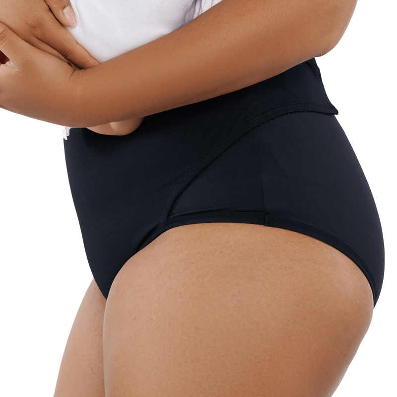 Lifestyle image of a postpartum woman wearing RoseRelief™ Postpartum Recovery Undergarment while holding her baby, shown for supportive recovery by Rose Maternity Co.